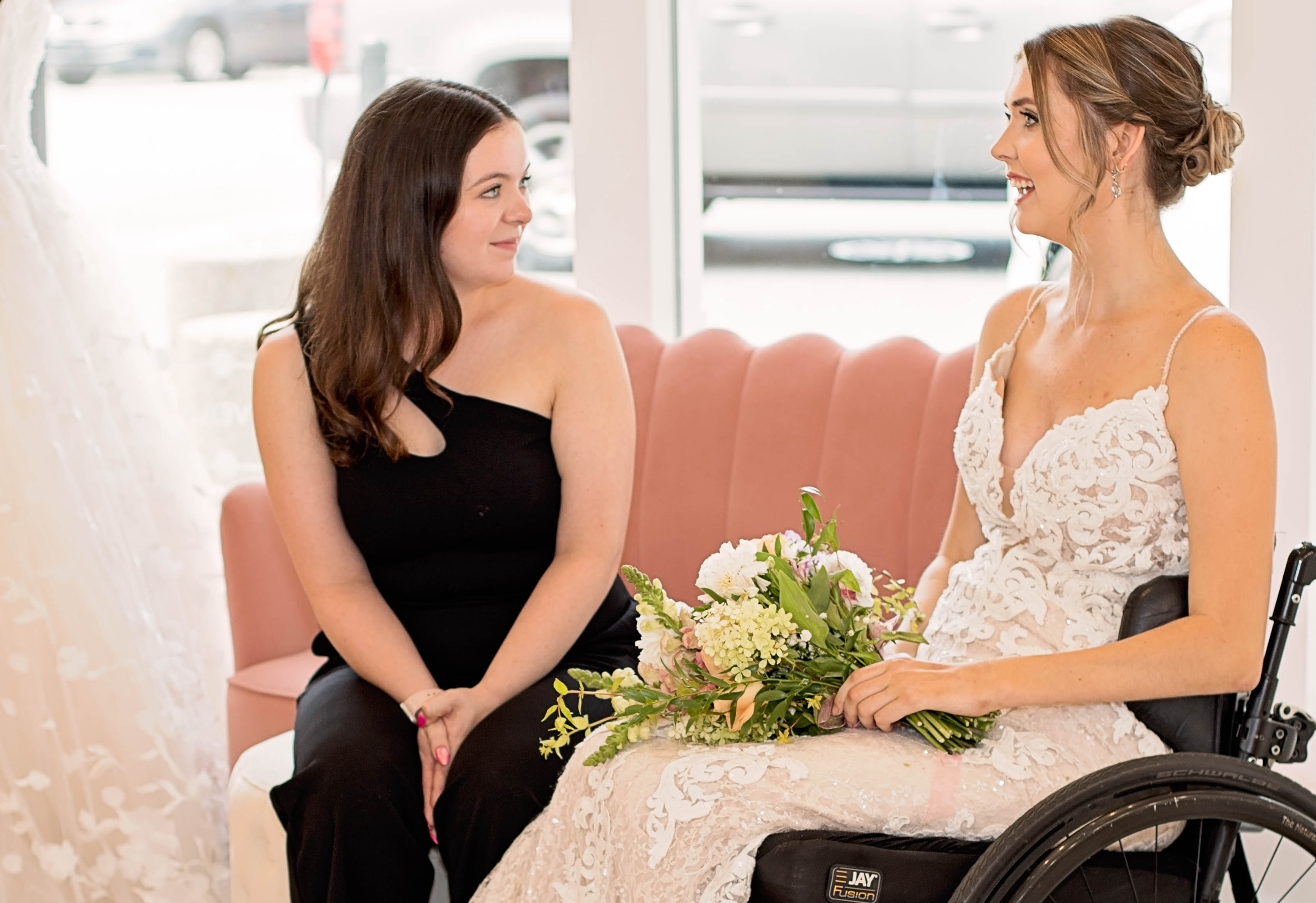 Founder Katie Horan talks with model Emma, sitting in her wheelchair.